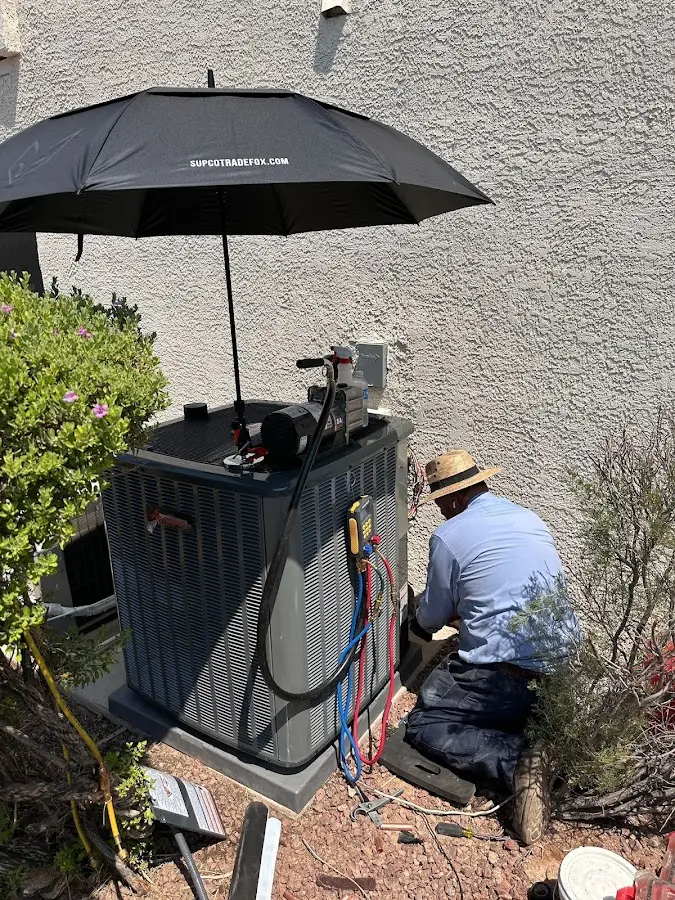 HVAC technician performing outdoor AC maintenance in Cornelius